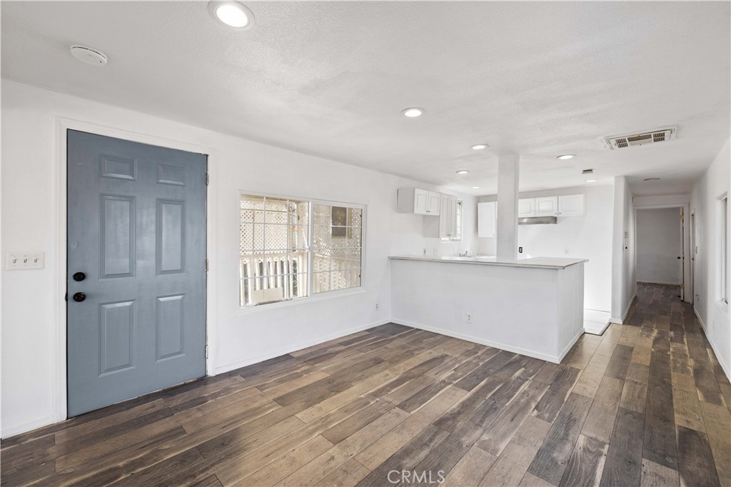 43850 20th Street East, Unit 265 Lancaster, CA 93535 - Photo 5 of 19 a view of wooden floor and windows in a room