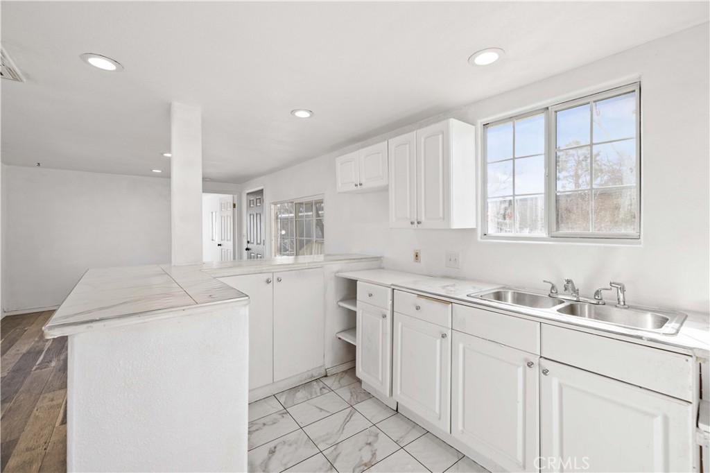 43850 20th Street East, Unit 265 Lancaster, CA 93535 - Photo 7 of 19 a kitchen with sink cabinets and window
