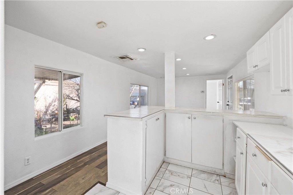 43850 20th Street East, Unit 265 Lancaster, CA 93535 - Photo 8 of 19 a kitchen with white cabinets and sink