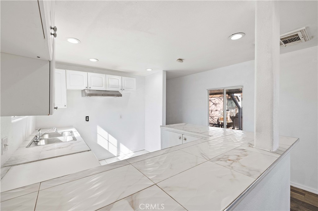 43850 20th Street East, Unit 265 Lancaster, CA 93535 - Photo 9 of 19 a view of a kitchen cabinets and window