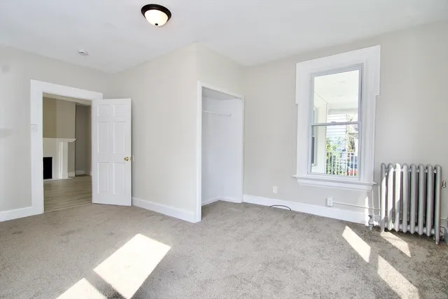 an empty room with windows and closet