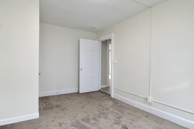 a view of room with window and hardwood floor