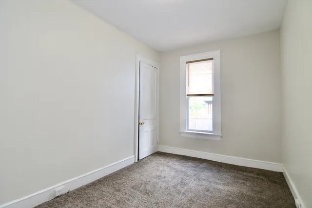 an empty room with closet area