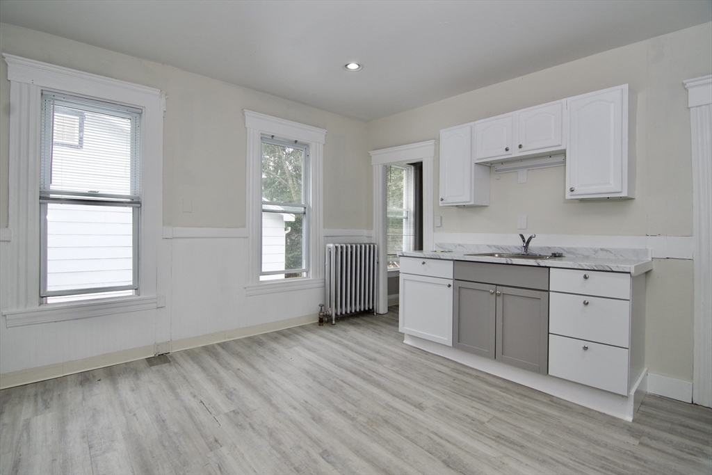 58 Howes Street, Unit 1 Springfield, MA 01118 - Photo 24 of 24 a kitchen with stainless steel appliances granite countertop a sink cabinets and wooden floor