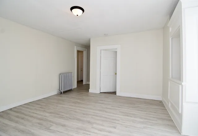 a view of an empty room and wooden floor
