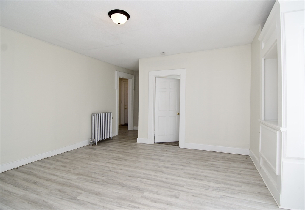 58 Howes Street, Unit 1 Springfield, MA 01118 - Photo 5 of 24 a view of an empty room and wooden floor