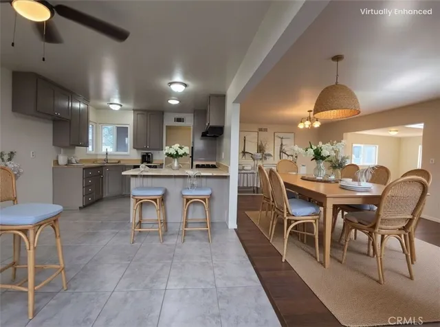 a dining area with a table chairs and a kitchen view