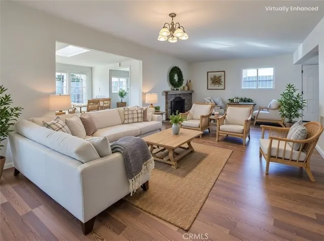 a living room with furniture wooden floor and a chandelier