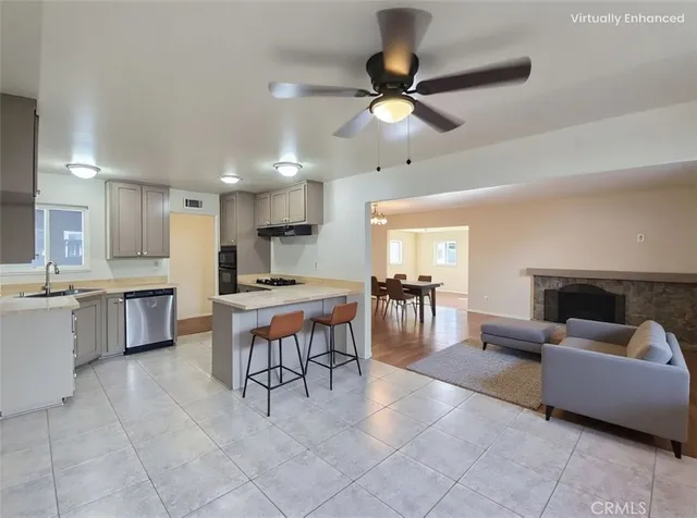 a living room with furniture a dining table and kitchen view
