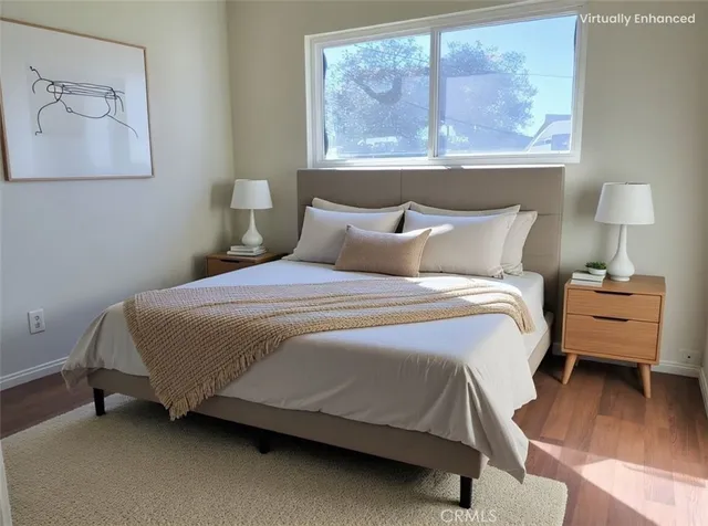 a bedroom with a bed and wooden floor