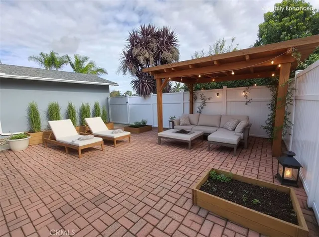a backyard of a house with barbeque oven table and chairs