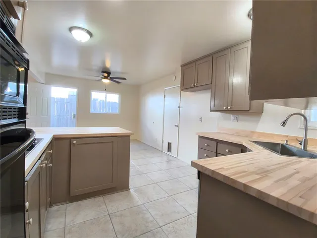a kitchen with a sink cabinets and appliances