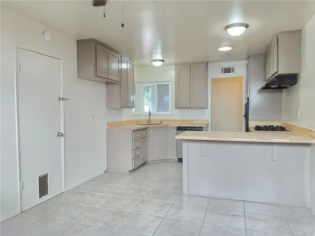 a kitchen with a sink stainless steel appliances and cabinets