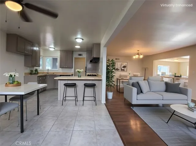 a living room with stainless steel appliances kitchen island granite countertop furniture and a view of kitchen