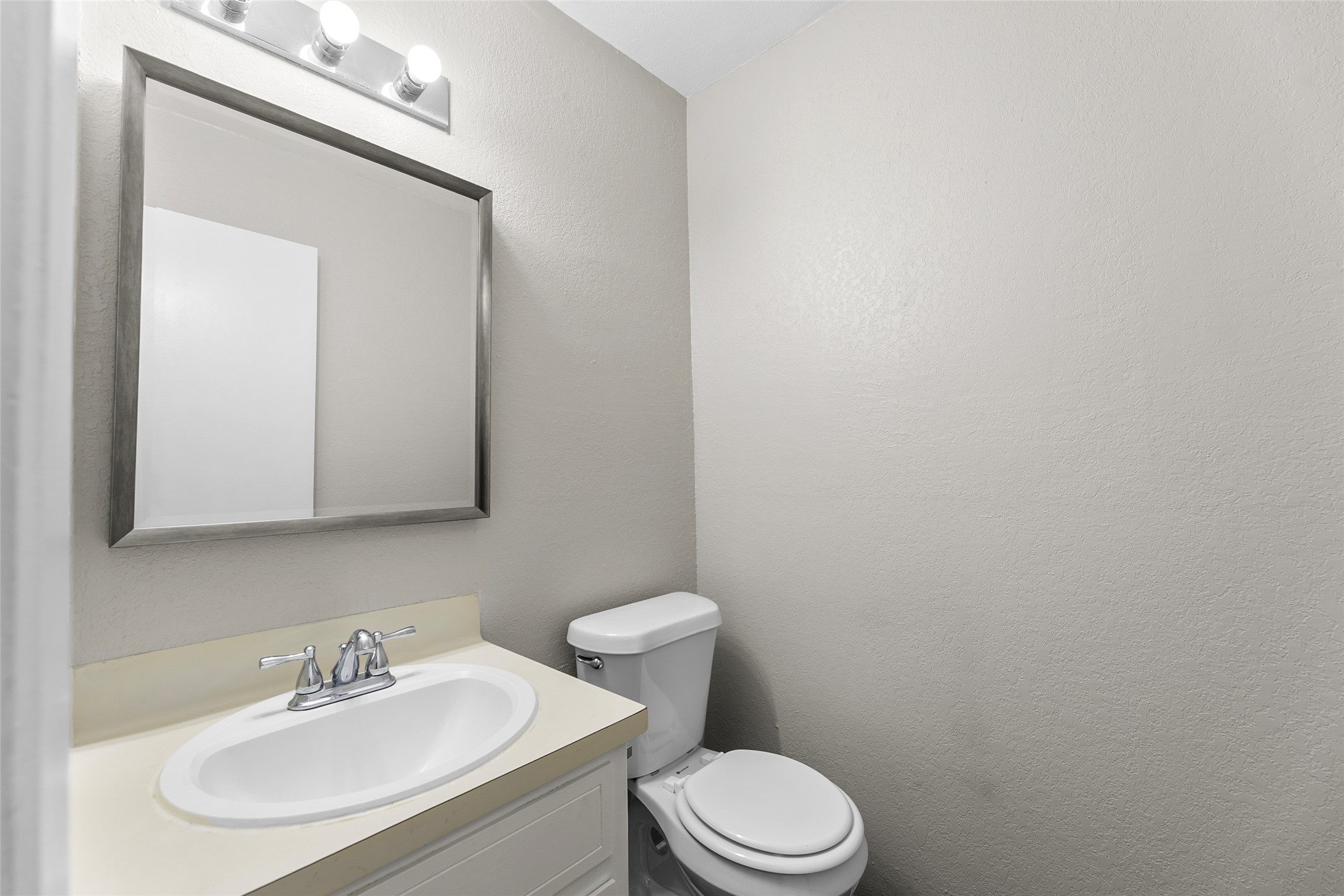 2107 Conestoga Trail, Unit A Austin, TX 78744 - Photo 10 of 22 Bathroom featuring vanity and a textured wall