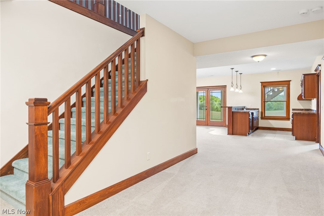 6925 River Styx Road Medina, OH 44256 - Photo 30 of 49 Hardwood staircase with green carpeted treads