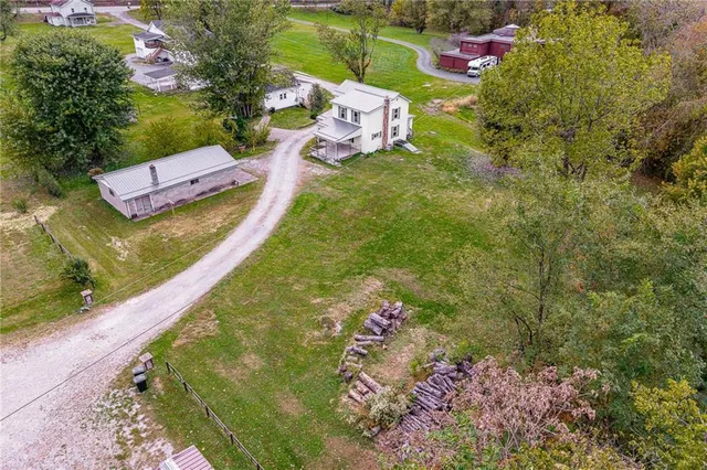 a view of a big room with wooden floor and windows