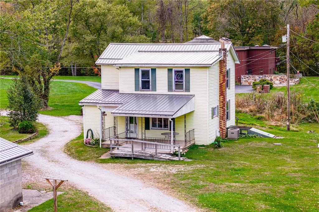 114 Post Road Dilliner, PA 15327 - Photo 24 of 50 a front view of a house with a garden