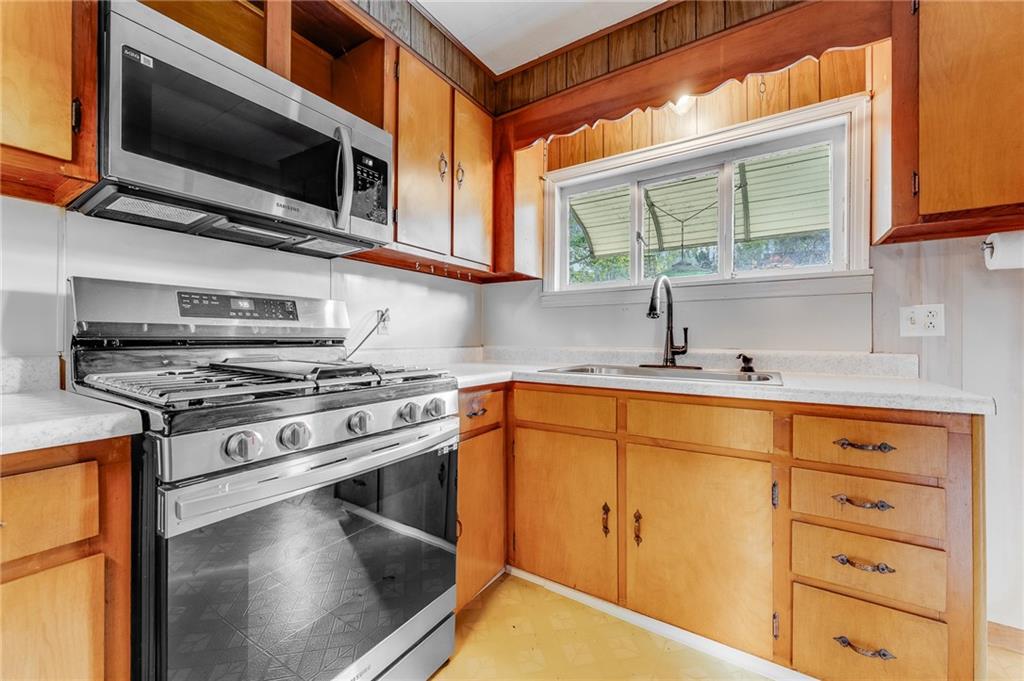 114 Post Road Dilliner, PA 15327 - Photo 43 of 50 a kitchen with stainless steel appliances granite countertop a sink a stove and microwave