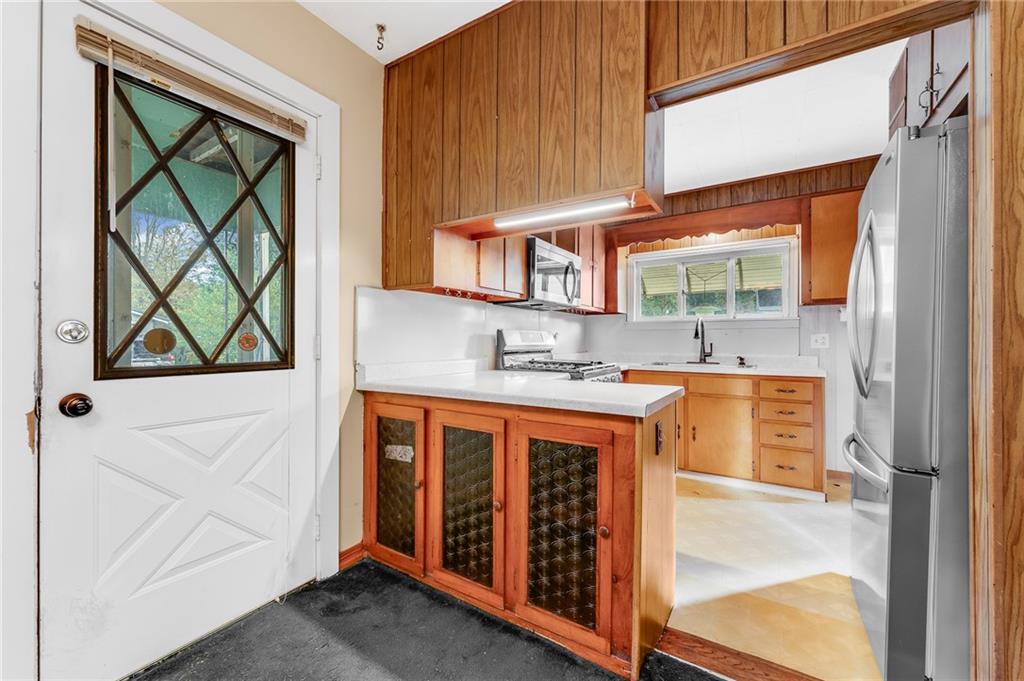 114 Post Road Dilliner, PA 15327 - Photo 46 of 50 a kitchen with stainless steel appliances granite countertop a stove a sink and a refrigerator with wooden floor