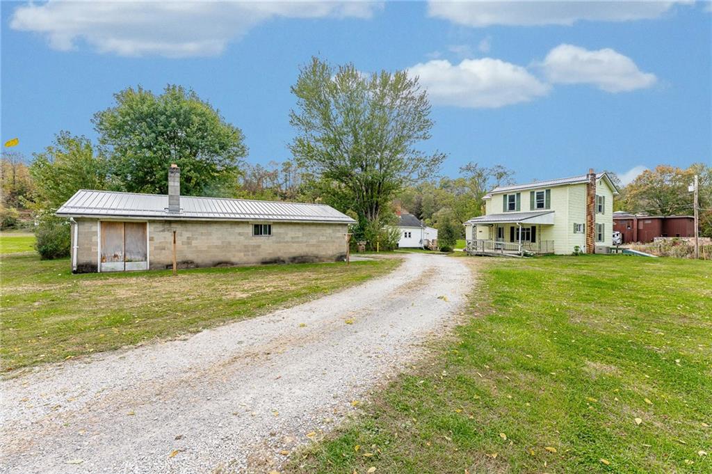 114 Post Road Dilliner, PA 15327 - Photo 7 of 50 a front view of a house with a yard and garage
