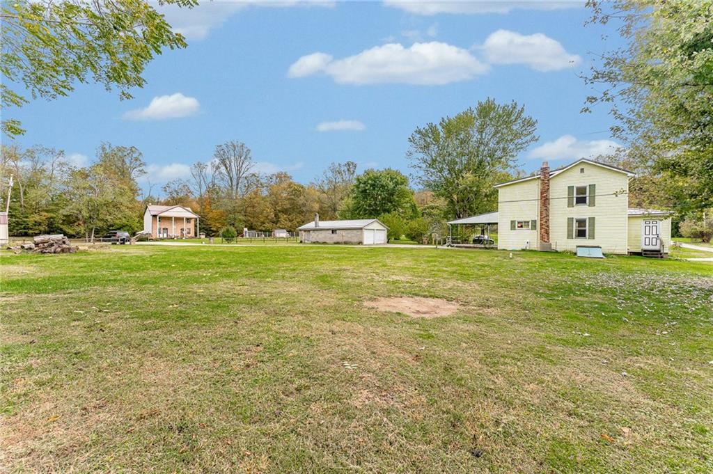 114 Post Road Dilliner, PA 15327 - Photo 10 of 50 a view of a tree in front of a house with a big yard