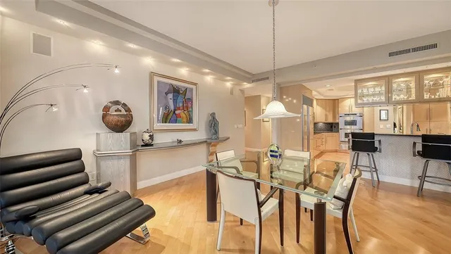 a dining room with wooden floor and furniture