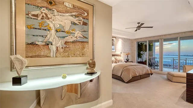 a bedroom with a bed and large window with balcony view