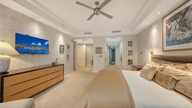 a spacious bedroom with a bed and a chandelier