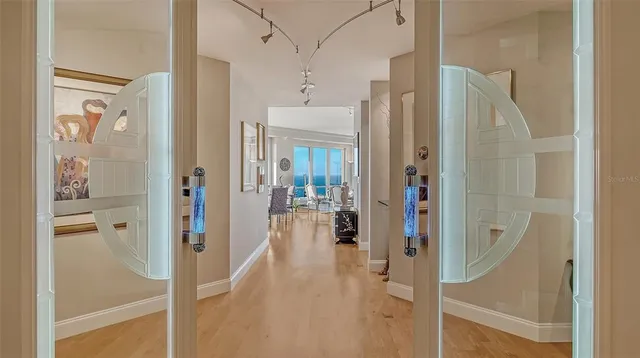 a dining room with furniture water mirror and a chandelier