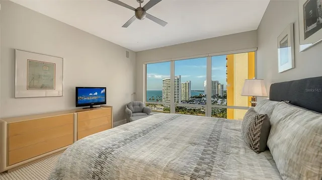 a bedroom with a bed a couch and dresser