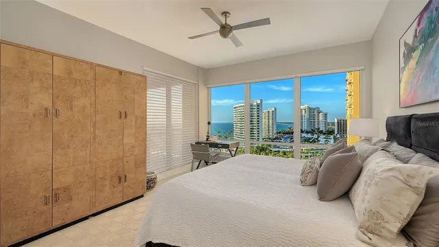 a bedroom with a bed and large window with outer view