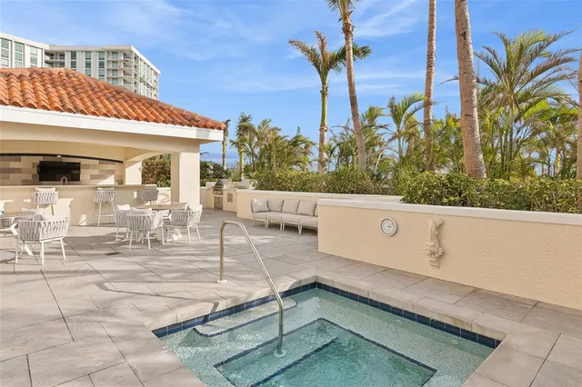 a view of a patio with couches and table and chairs and potted plants