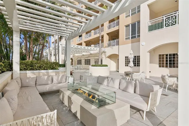 a view of a patio with couches chairs and wooden floor