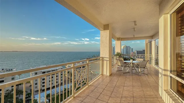 a kitchen with stainless steel appliances kitchen island granite countertop a stove and a white cabinets