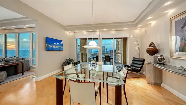 a kitchen with stainless steel appliances kitchen island granite countertop a stove and a white cabinets