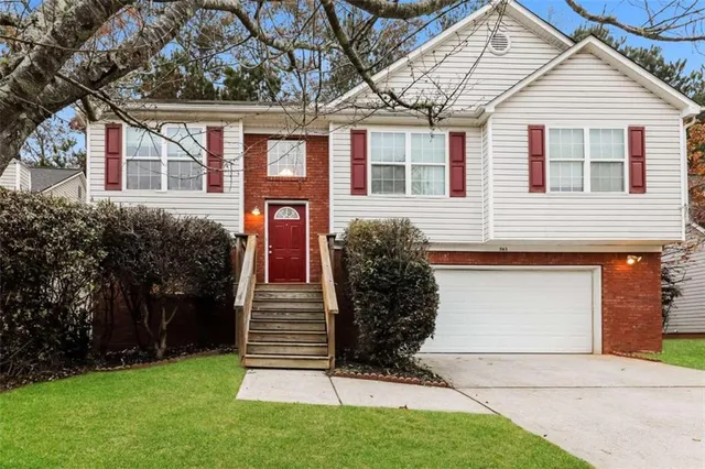 a front view of a house with a garden