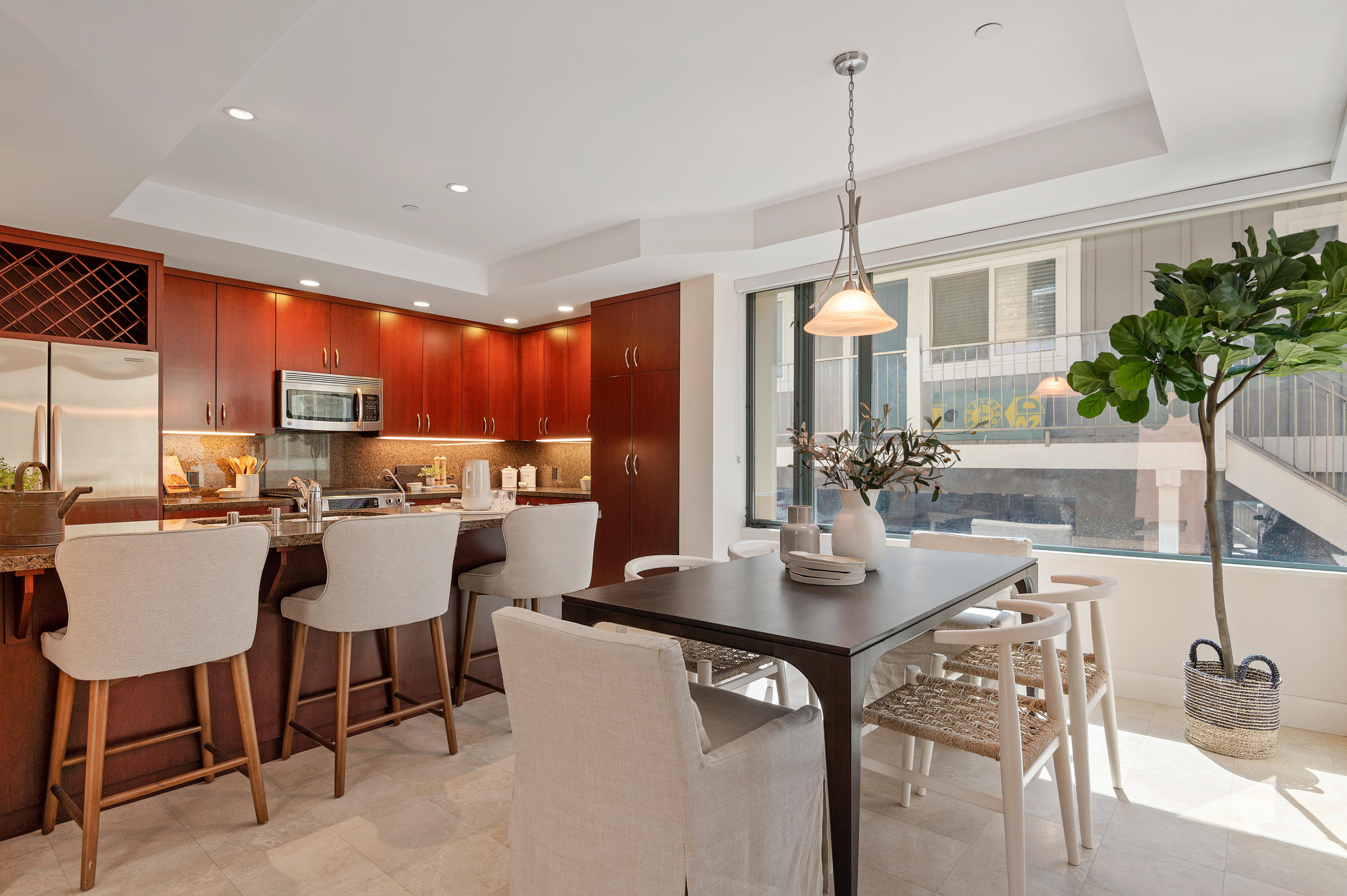 4815 Sandyland Road, Unit A Carpinteria, CA 93013 - Photo 11 of 29 a kitchen with a dining table chairs and white cabinets