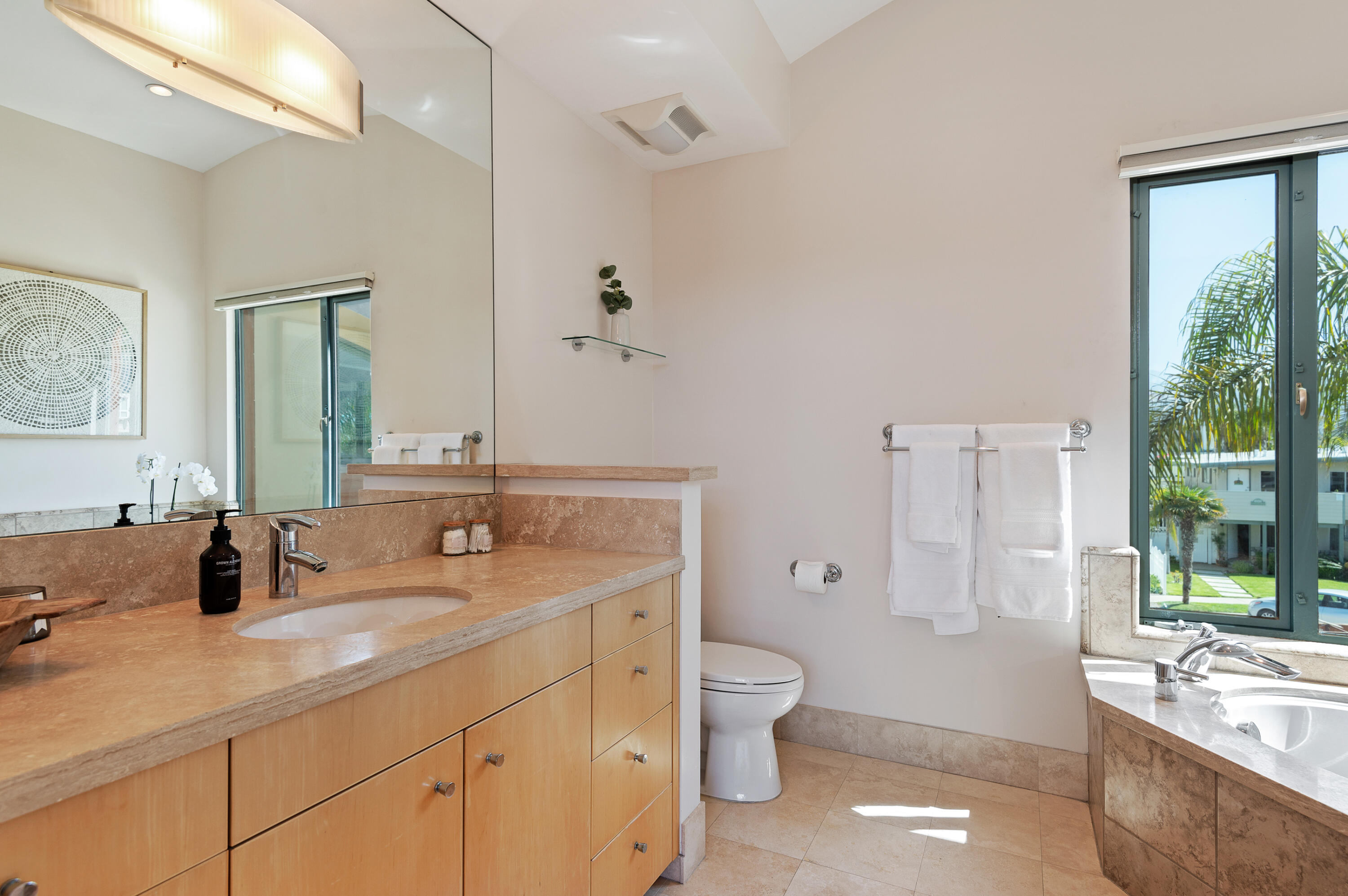 4815 Sandyland Road, Unit A Carpinteria, CA 93013 - Photo 17 of 29 a bathroom with a granite countertop toilet sink and mirror