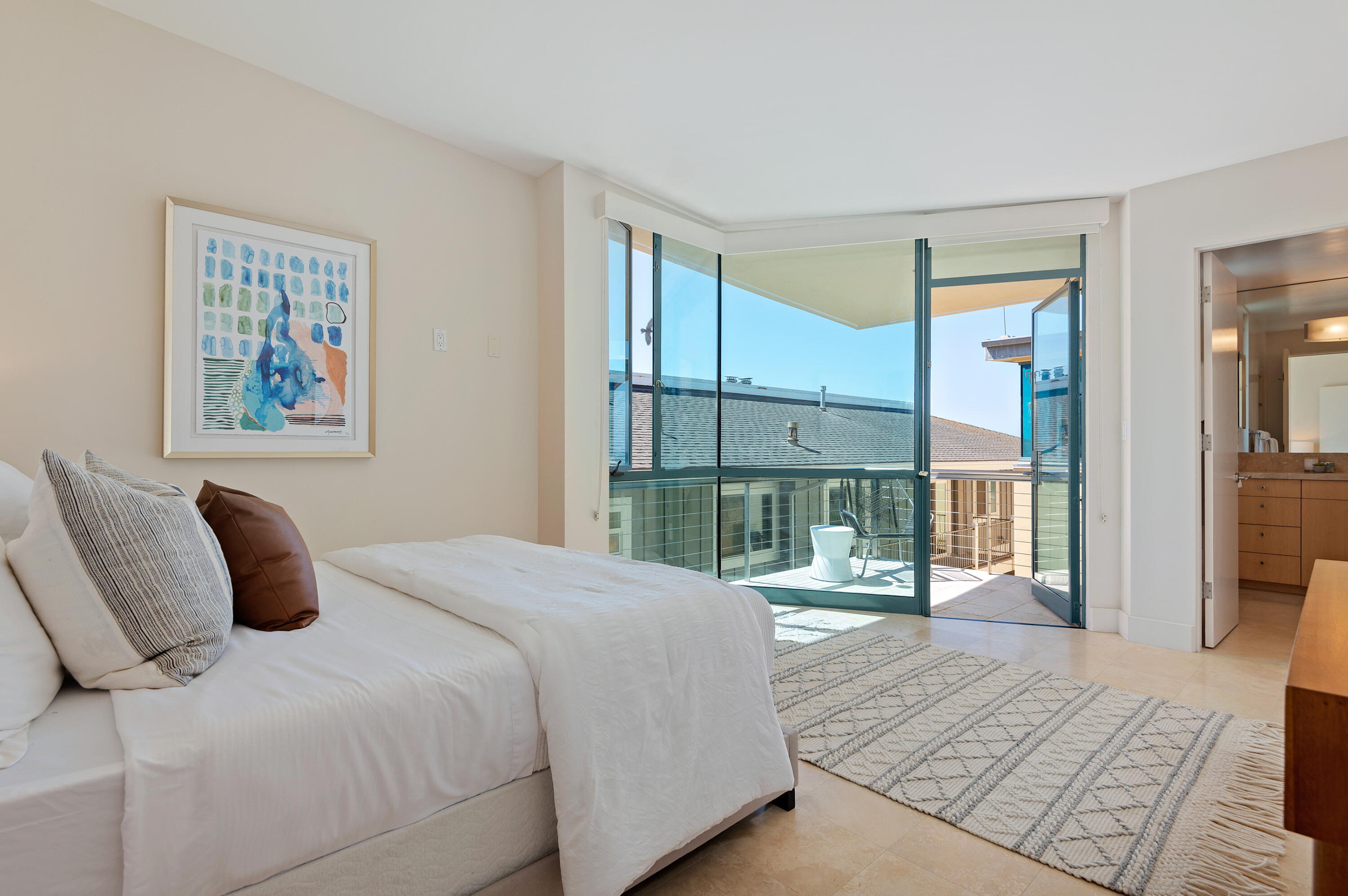 4815 Sandyland Road, Unit A Carpinteria, CA 93013 - Photo 19 of 29 a bedroom with a bed and large window with balcony view