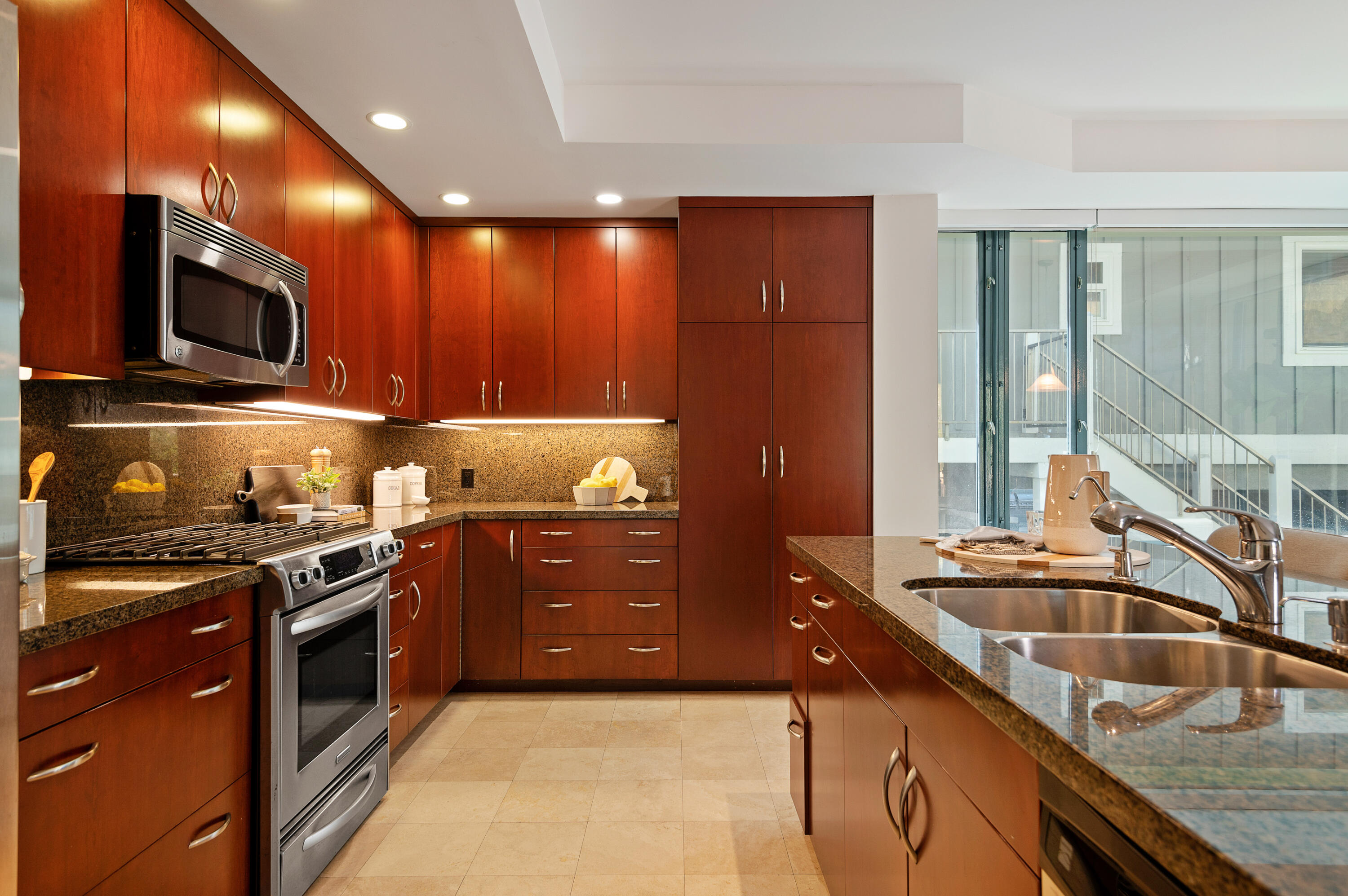 4815 Sandyland Road, Unit A Carpinteria, CA 93013 - Photo 10 of 29 a kitchen with stainless steel appliances granite countertop a sink a stove and a wooden cabinets