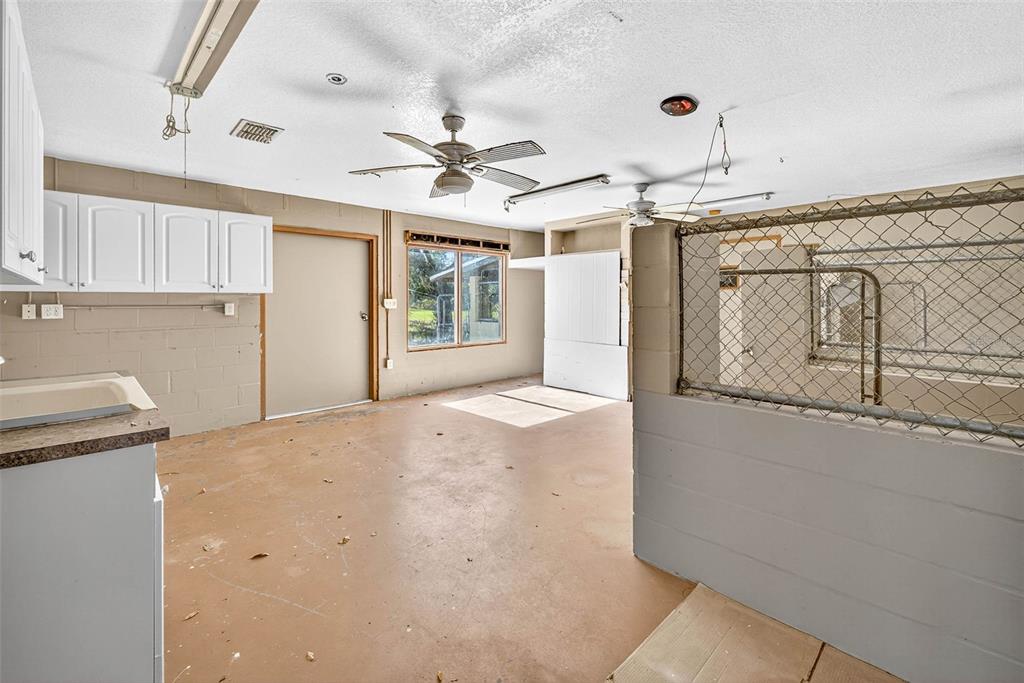 14252 Trinity Road Brooksville, FL 34614 - Photo 20 of 26 a view of a hallway with a chandelier