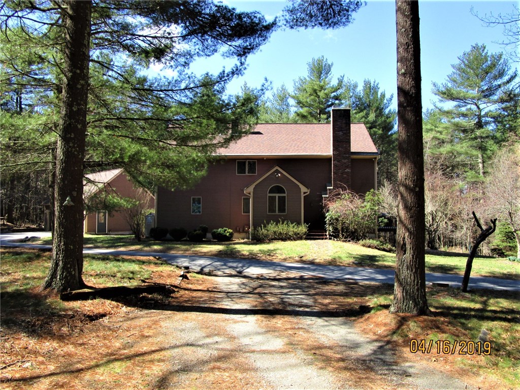 FRONT OF HOME PORCH WITH STAIRS NEAR CHIMNEY