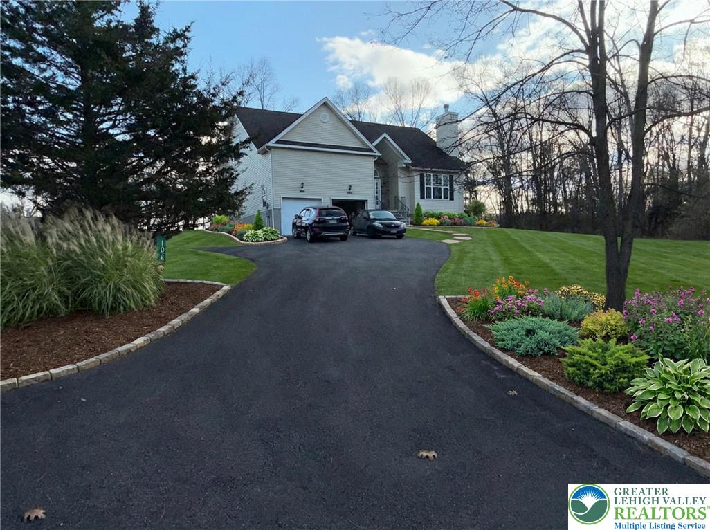 106 Hilda Court East Stroudsburg, PA 18301 - Photo 2 of 33 a front view of a house with a garden and pathway