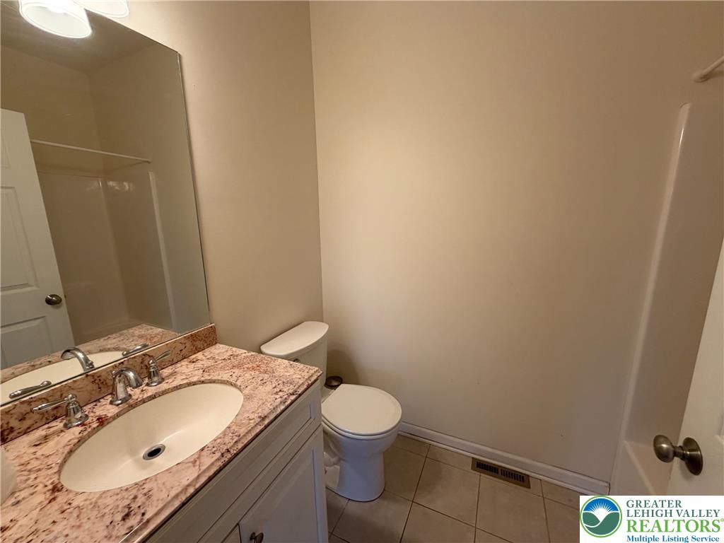 106 Hilda Court East Stroudsburg, PA 18301 - Photo 26 of 33 a bathroom with a granite countertop sink toilet and a mirror