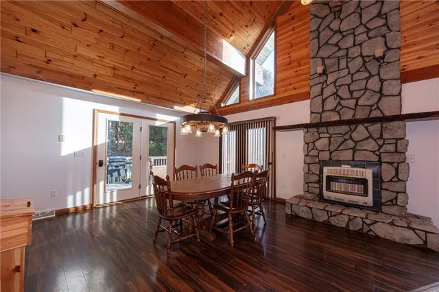 a dining room with furniture a fireplace and wooden floor