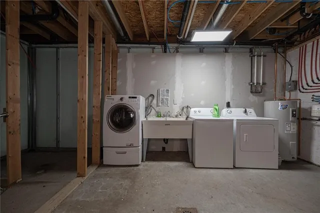a utility room with cabinets dryer and washer