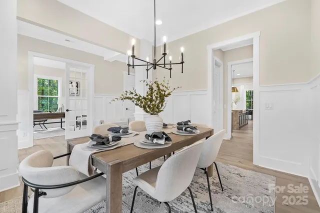 a view of a dining room with furniture and a chandelier