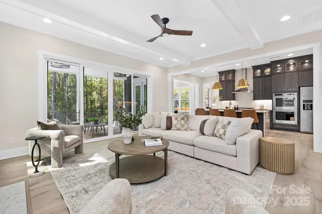 a living room with furniture and large windows