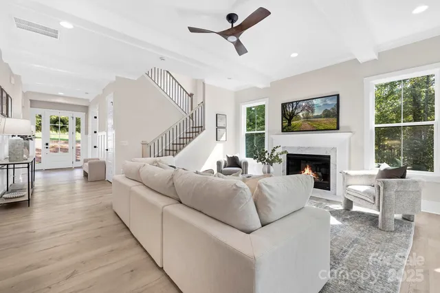 a living room with furniture fireplace and a flat screen tv
